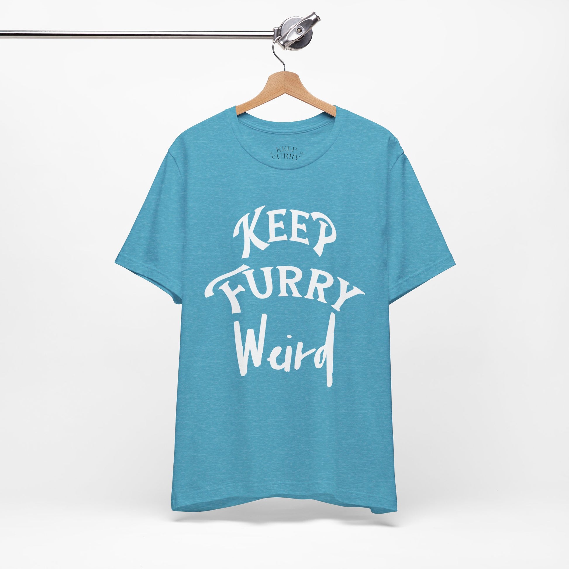 Blue t-shirt with 'Keep Furry Weird' text on a hanger against a white background
