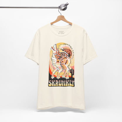 White t-shirt with a coyote design of a tiger and 'Skrunkly' text on a hanger against a white background