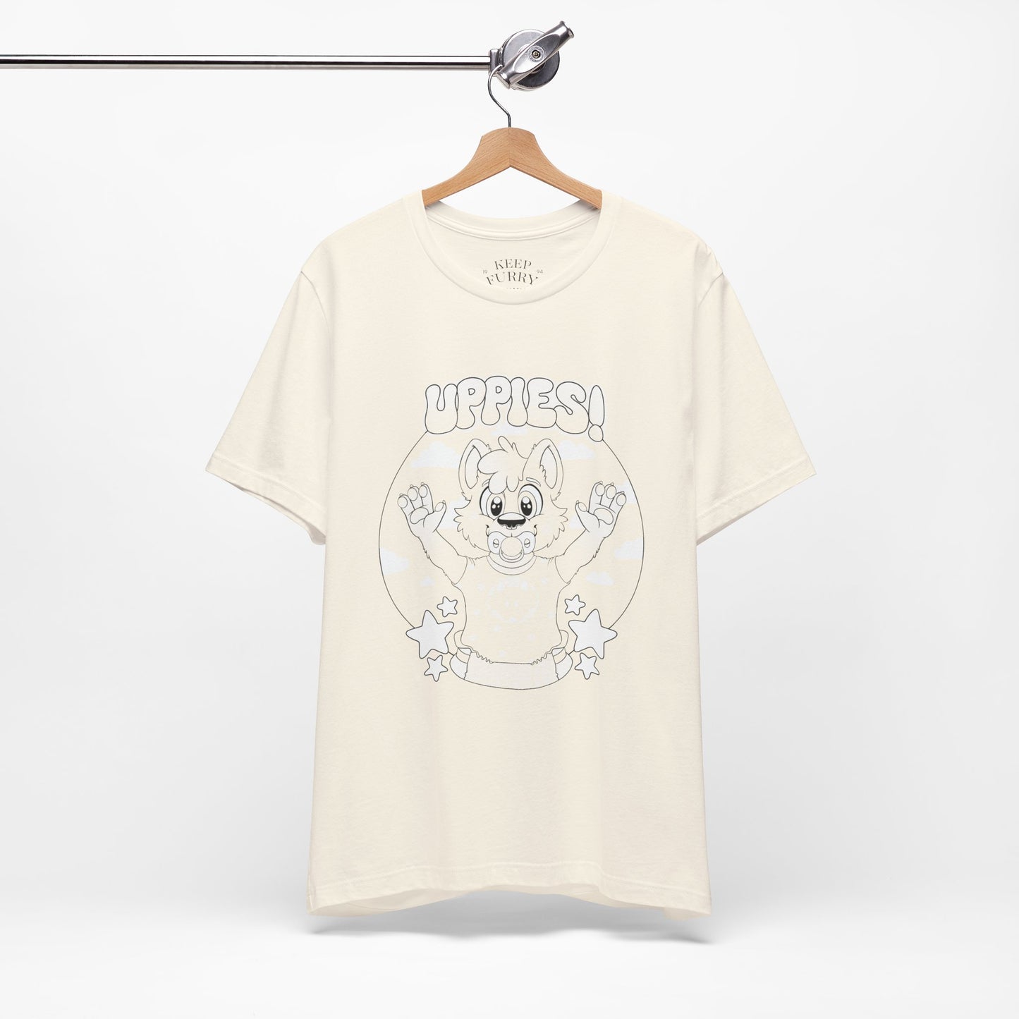 Beige t-shirt with cartoon baby dog graphic and 'uppies!' text on a white background