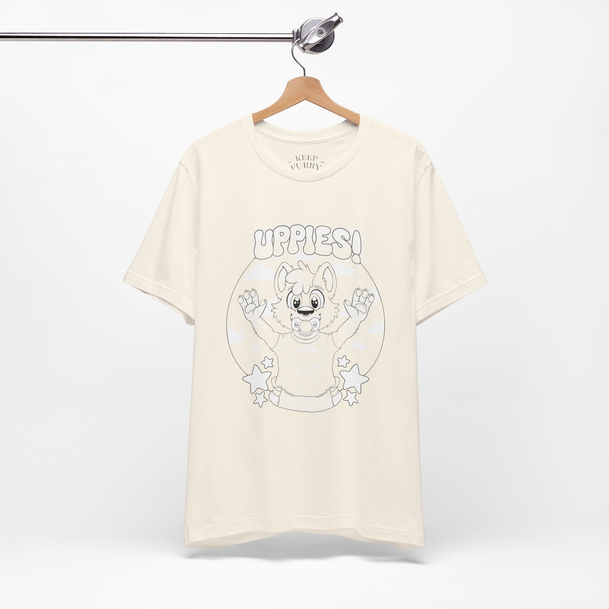 Beige t-shirt with cartoon baby dog graphic and 'uppies!' text on a white background