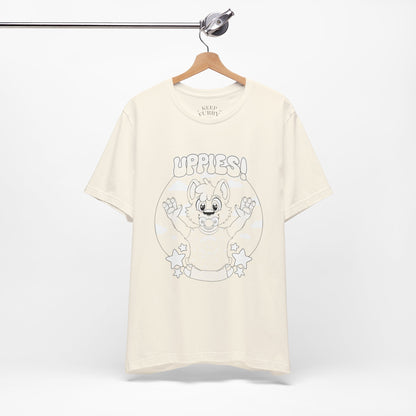 Beige t-shirt with cartoon baby dog graphic and 'uppies!' text on a white background