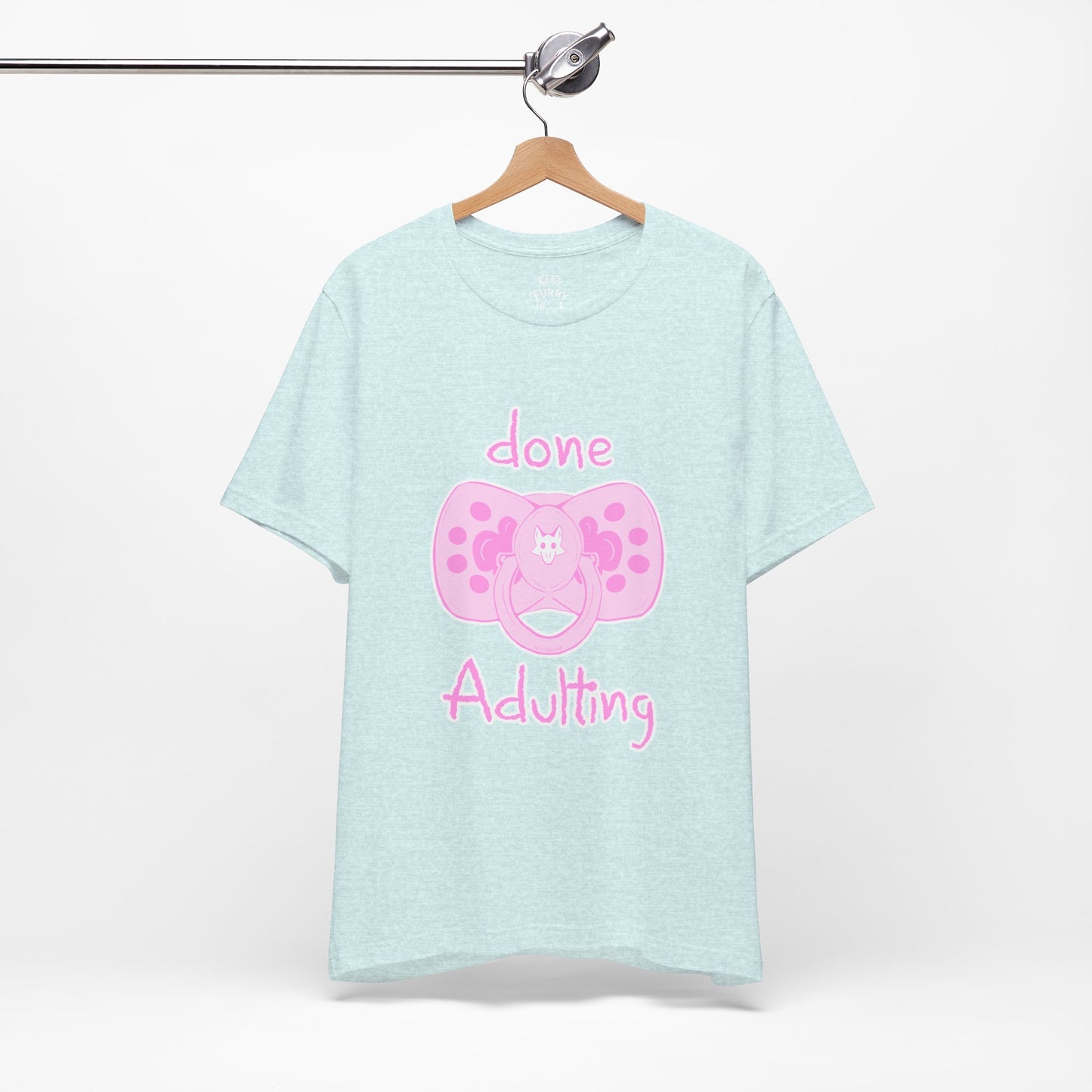 Light blue t-shirt with pink pacifier graphic and text on a white background