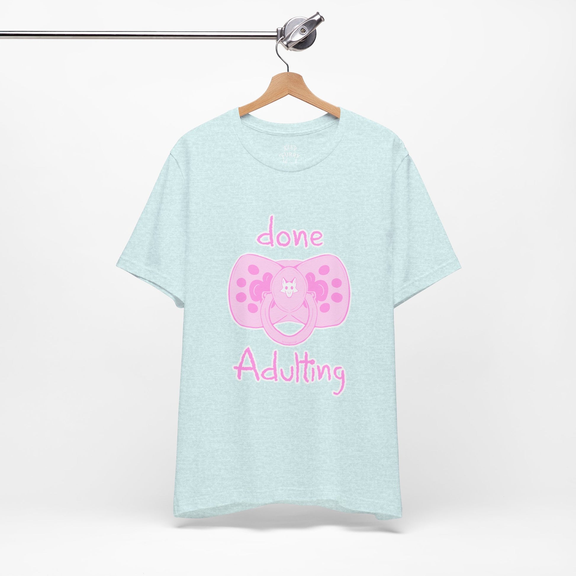 Light blue t-shirt with pink pacifier graphic and text on a white background
